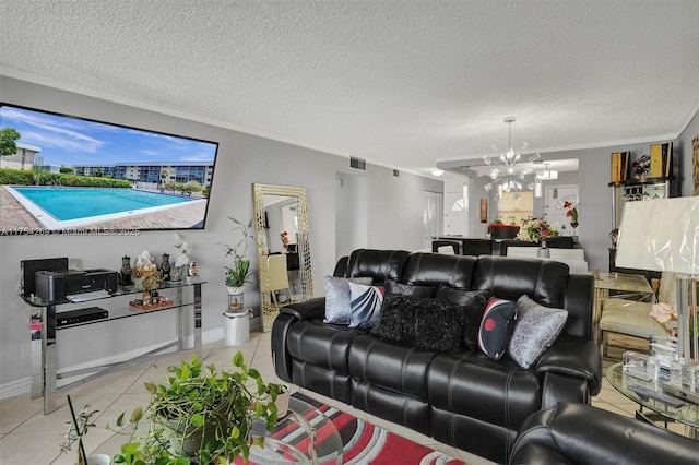 living area featuring light tile patterned floors, visible vents, ornamental molding, a textured ceiling, and a notable chandelier