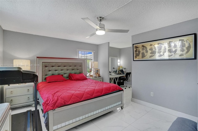 bedroom featuring a ceiling fan, marble finish floor, a textured ceiling, and baseboards