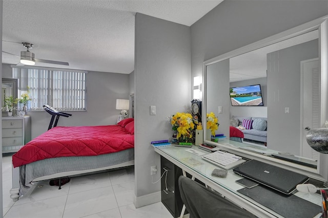 bedroom with baseboards and a textured ceiling