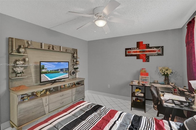 bedroom featuring a ceiling fan, tile patterned flooring, a textured ceiling, and baseboards