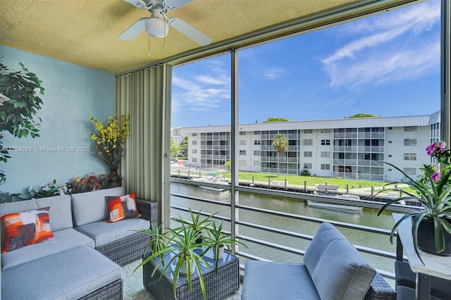 exterior space featuring a water view and ceiling fan