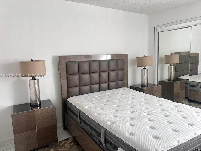 bedroom with a closet and a textured ceiling