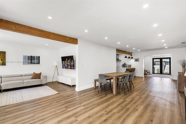 dining space with visible vents, baseboards, light wood-style floors, beam ceiling, and recessed lighting