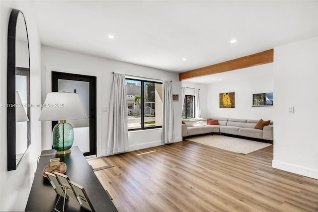 living room with beam ceiling, baseboards, wood finished floors, and recessed lighting