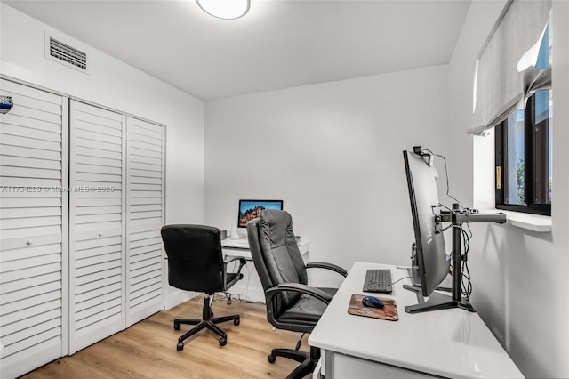 office featuring light wood-style floors and visible vents