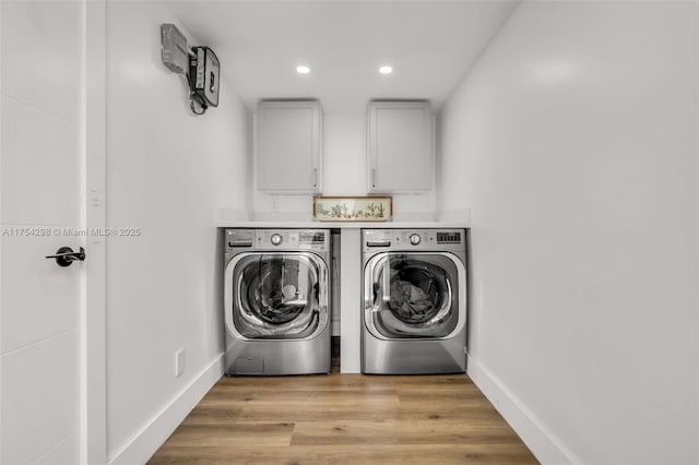 clothes washing area with cabinet space, baseboards, washer and clothes dryer, light wood-style floors, and recessed lighting