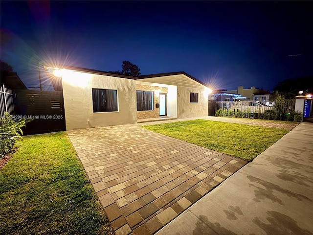 1761 SW 17th St, Miami, FL 33145 - back of house at twilight with stucco siding and a patio area