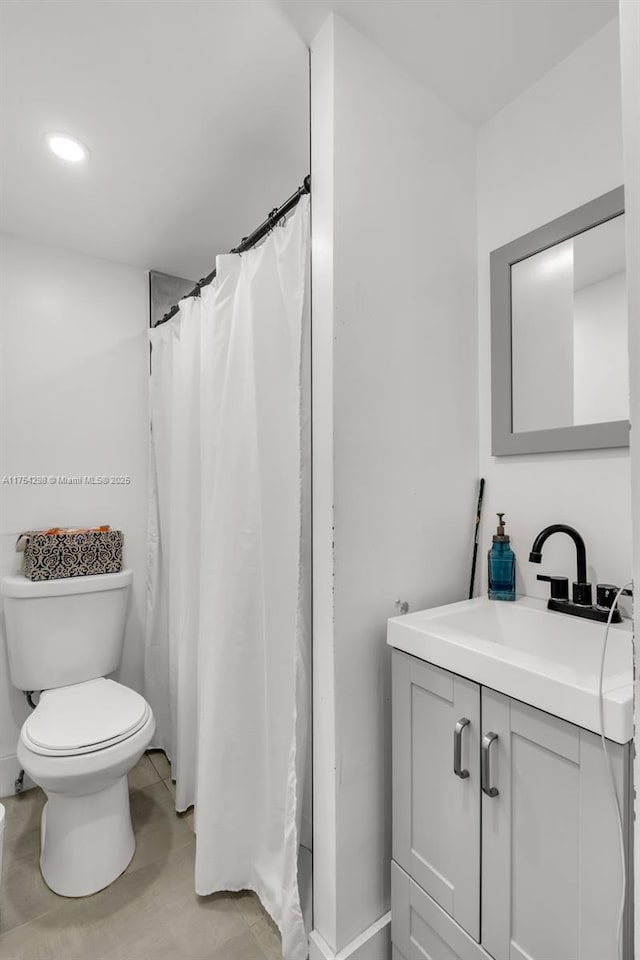 full bathroom featuring vanity and toilet