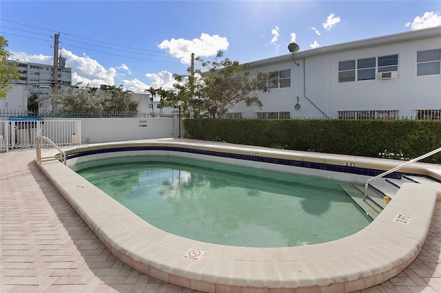 view of swimming pool with a swimming pool and fence