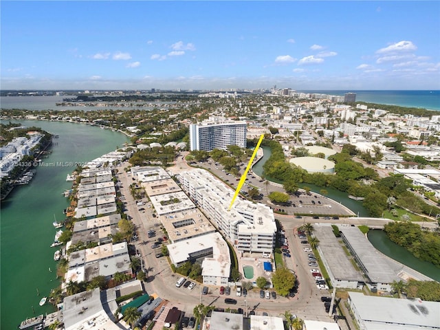 birds eye view of property featuring a water view and a view of city