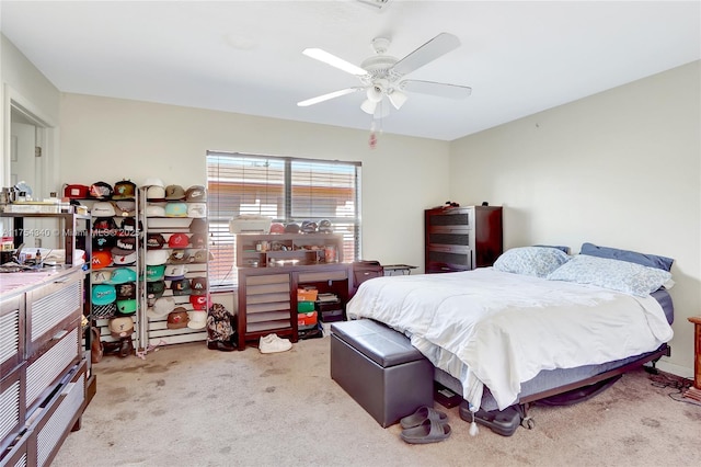 bedroom with a ceiling fan and carpet