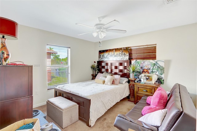 bedroom with light carpet, ceiling fan, and baseboards