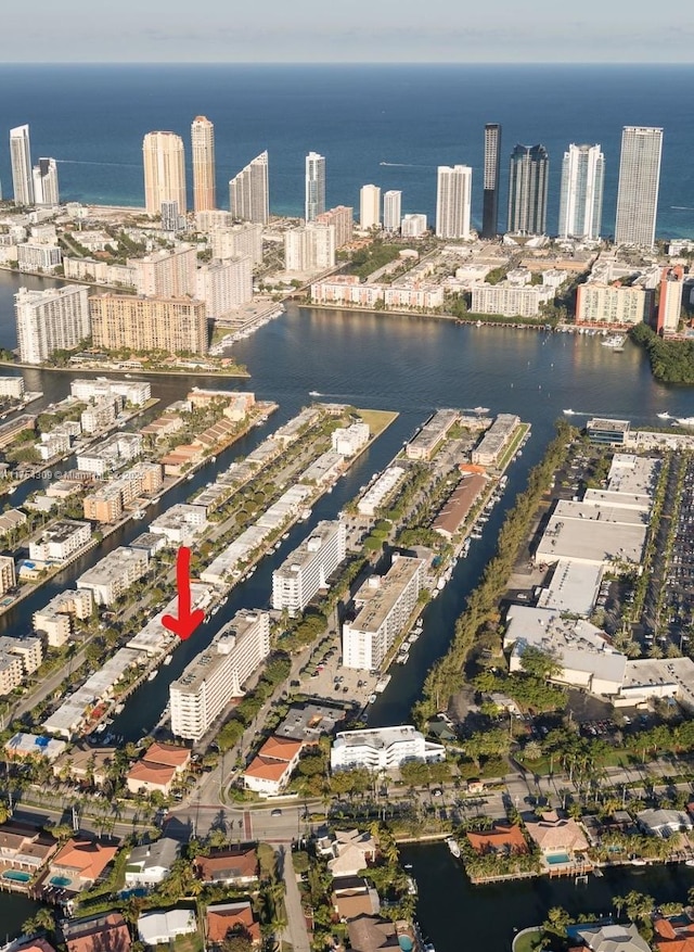 birds eye view of property featuring a view of city and a water view