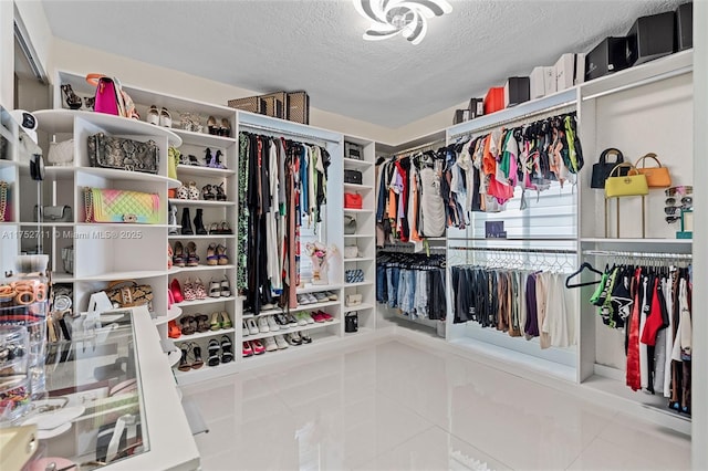 walk in closet with tile patterned flooring