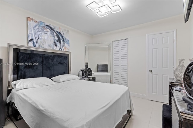 bedroom with a closet and light tile patterned flooring