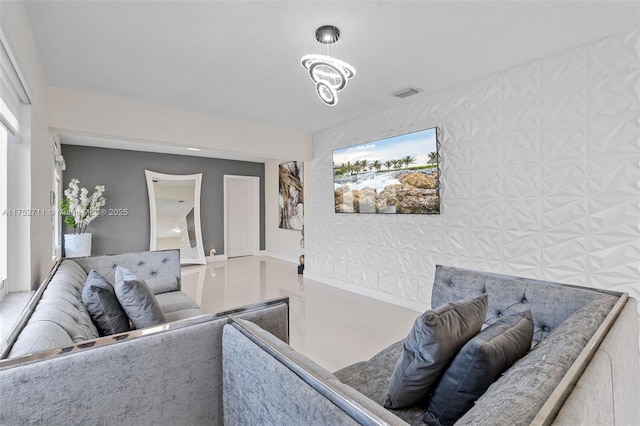 living area featuring baseboards, visible vents, and wallpapered walls