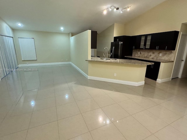 162 NW 207th Ave, Pembroke Pines, FL 33029 - kitchen featuring freestanding refrigerator, dark cabinets, a sink, decorative backsplash, and open floor plan