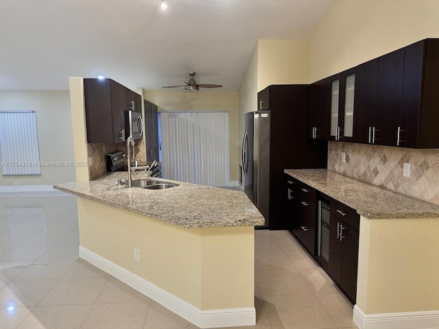 162 NW 207th Ave, Pembroke Pines, FL 33029 - kitchen featuring appliances with stainless steel finishes, light tile patterned floors, a sink, tasteful backsplash, and a ceiling fan