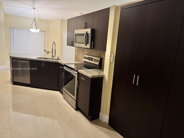 162 NW 207th Ave, Pembroke Pines, FL 33029 - kitchen featuring appliances with stainless steel finishes, decorative backsplash, a peninsula, a sink, and light stone counters