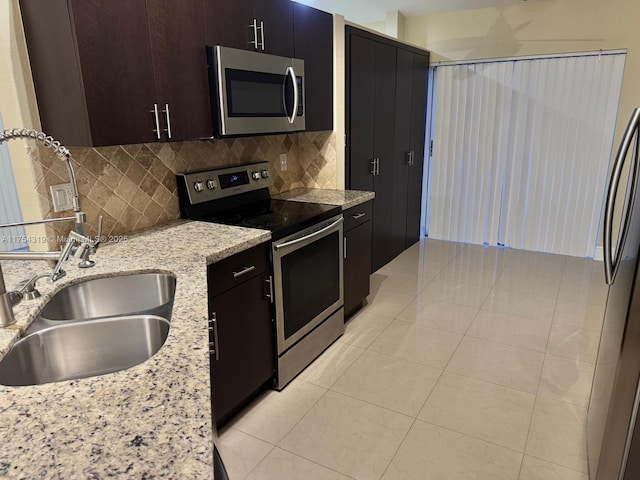 162 NW 207th Ave, Pembroke Pines, FL 33029 - kitchen with stainless steel appliances, tasteful backsplash, a sink, and light tile patterned flooring