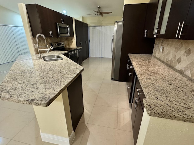 162 NW 207th Ave, Pembroke Pines, FL 33029 - kitchen featuring stainless steel appliances, a sink, ceiling fan, light tile patterned floors, and light stone counters