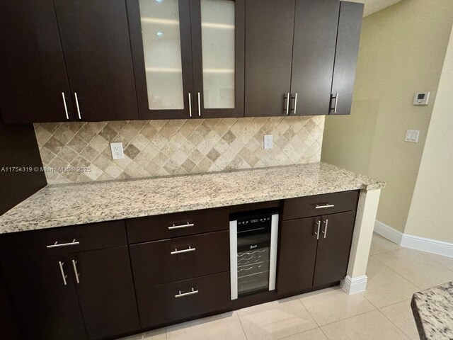 162 NW 207th Ave, Pembroke Pines, FL 33029 - kitchen featuring wine cooler, backsplash, baseboards, light tile patterned flooring, and glass insert cabinets