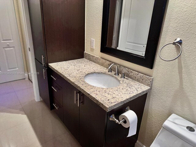 162 NW 207th Ave, Pembroke Pines, FL 33029 - bathroom featuring vanity, tile patterned floors, a textured wall, and toilet