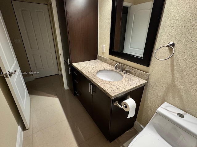 162 NW 207th Ave, Pembroke Pines, FL 33029 - bathroom with a textured wall, vanity, tile patterned floors, toilet, and baseboards