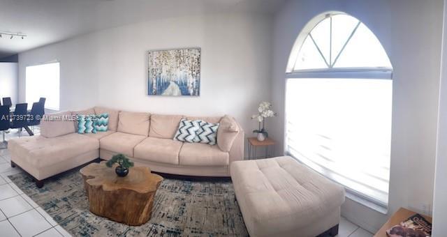 living room with tile patterned flooring