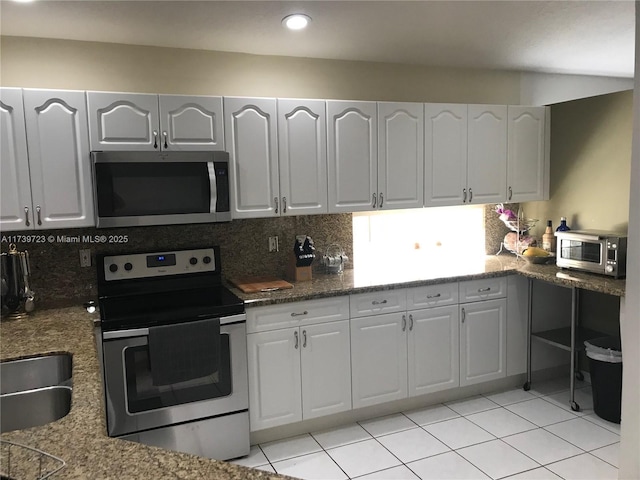 16654 SW 103rd Ln, Miami, FL 33196 - kitchen with a sink, stainless steel appliances, decorative backsplash, and light tile patterned flooring