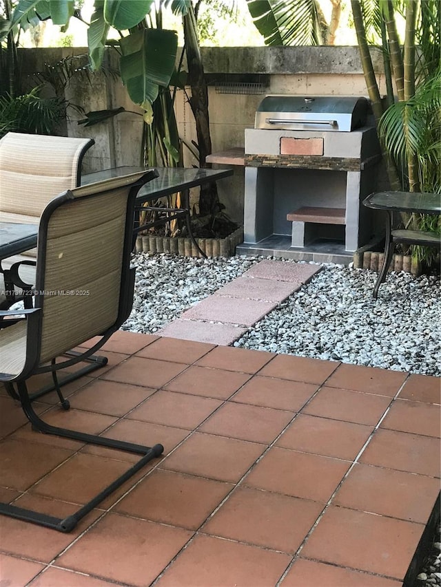 16654 SW 103rd Ln, Miami, FL 33196 - view of patio featuring exterior kitchen and fence