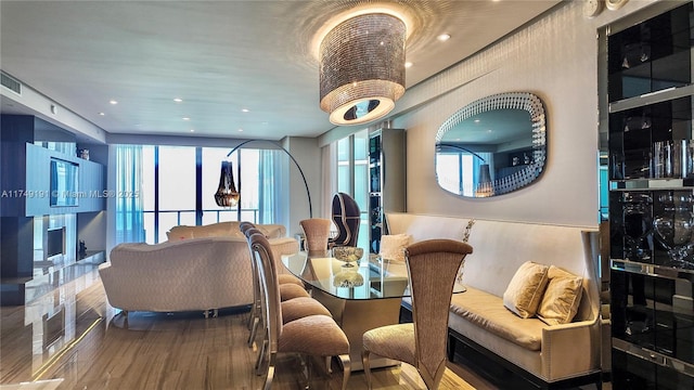 dining area with wood finished floors and recessed lighting