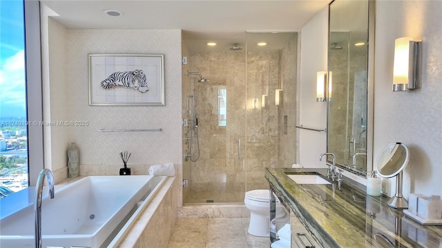 bathroom with toilet, a shower stall, vanity, and a whirlpool tub