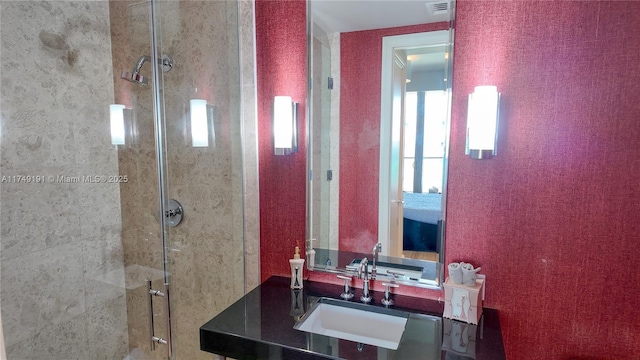 full bath with a stall shower, visible vents, and vanity