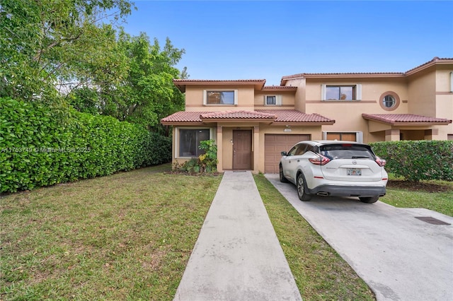 view of front of house featuring a garage, driveway, stucco siding, a tile roof, and a front yard