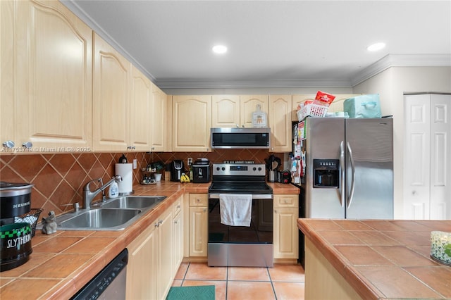 kitchen featuring light tile patterned floors, tile counters, backsplash, appliances with stainless steel finishes, and a sink