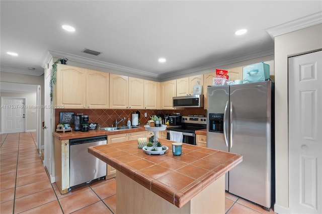 kitchen featuring tile countertops, light tile patterned floors, stainless steel appliances, visible vents, and decorative backsplash