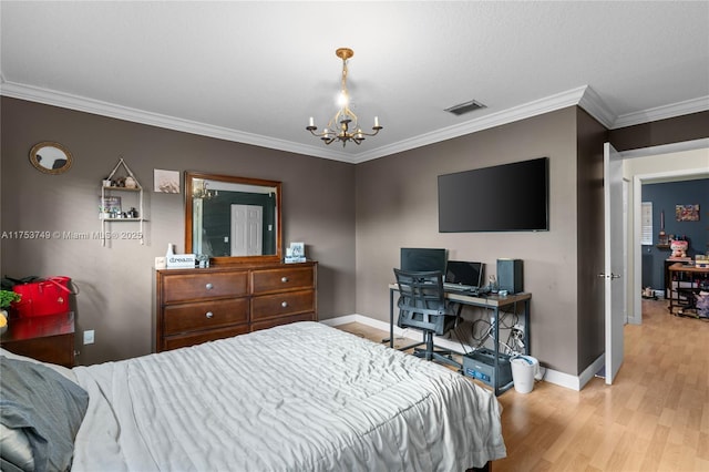 bedroom with baseboards, wood finished floors, visible vents, and a notable chandelier