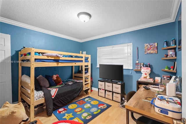 bedroom featuring ornamental molding, a textured ceiling, and wood finished floors