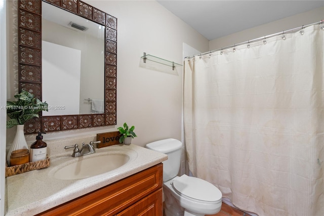 full bathroom with visible vents, vanity, and toilet