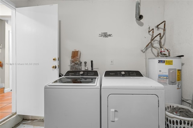 clothes washing area featuring laundry area, water heater, and separate washer and dryer