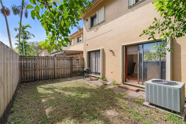 view of yard with central AC unit and a fenced backyard