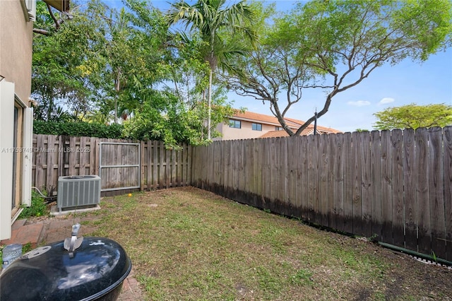 view of yard with a fenced backyard and cooling unit