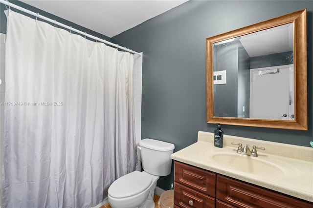 bathroom featuring toilet, a shower with shower curtain, and vanity