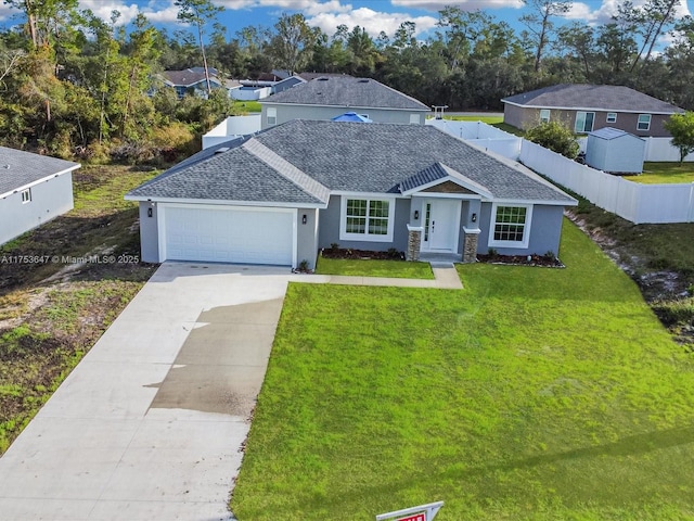 single story home featuring a garage, driveway, a shingled roof, fence, and a front lawn