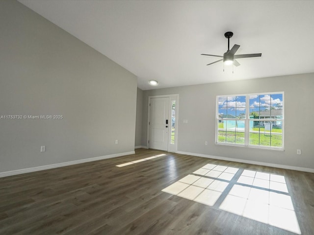 interior space featuring dark wood-type flooring, a ceiling fan, and baseboards