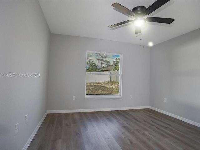 unfurnished room with wood finished floors, a ceiling fan, and baseboards