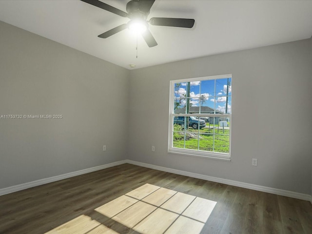 unfurnished room featuring wood finished floors, a ceiling fan, and baseboards