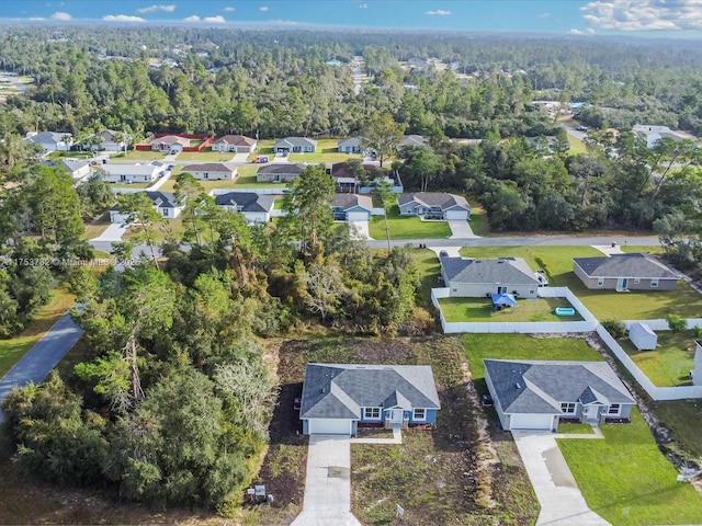 drone / aerial view with a residential view and a view of trees