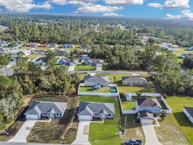 birds eye view of property featuring a forest view and a residential view